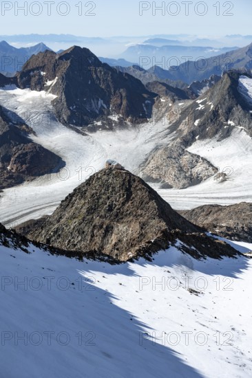 At the Wilder Freiger summit, picturesque high mountain landscape with snow, view of the