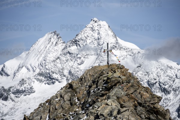 Summit cross of the summit Böses Weibl, behind summit of the Großglockner with snow, Schober group,