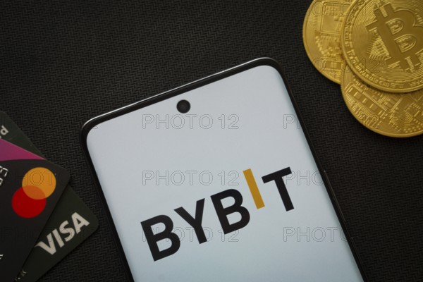 Dhaka, Bangladesh- 15 July 2025: Smartphone displaying Bybit logo surrounded by Bitcoin coins and
