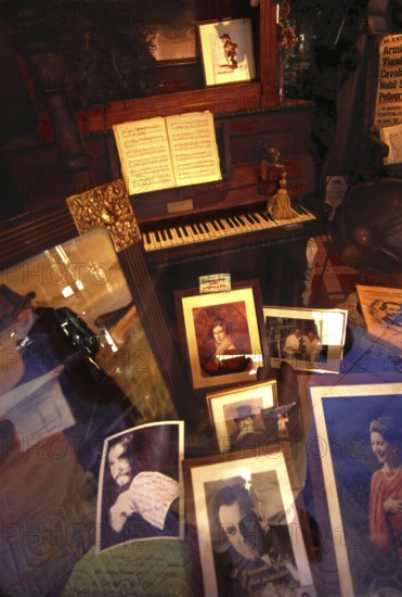 Shop window decoration in honor of Giuseppe Verdi, with pictures of opera Opera singer and