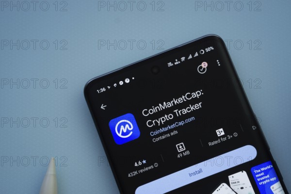 Dhaka, Bangladesh- 29 May 2025: On a blue surface, a smartphone displays the Coinmarketcap app