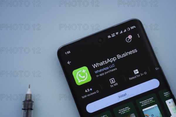 Dhaka, Bangladesh- 29 May 2025: On a blue surface, a smartphone displays the WhatsApp Business app
