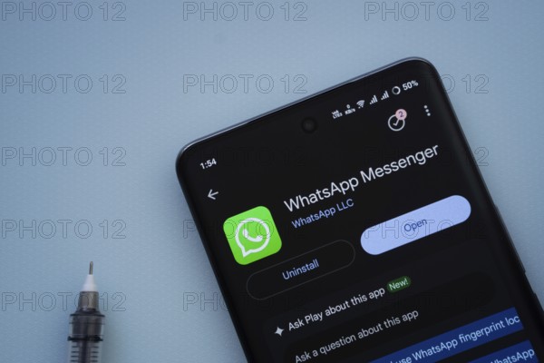 Dhaka, Bangladesh- 29 May 2025: On a blue surface, a smartphone displays the WhatsApp Messenger app