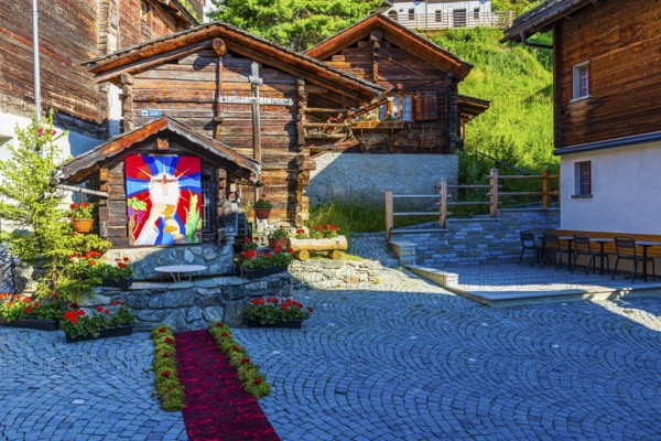 Flower-decorated altar for the Corpus Christi procession, historic village centre, Grimentz, Val