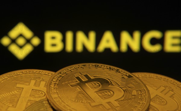 Dhaka, Bangladesh- 22 June 2025: Close-up of Bitcoin coins with the Binance logo visible on a