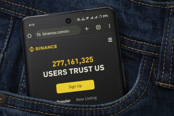 Dhaka, Bangladesh- 15 June 2025: A smartphone displaying the binance.com web interface peeks out of