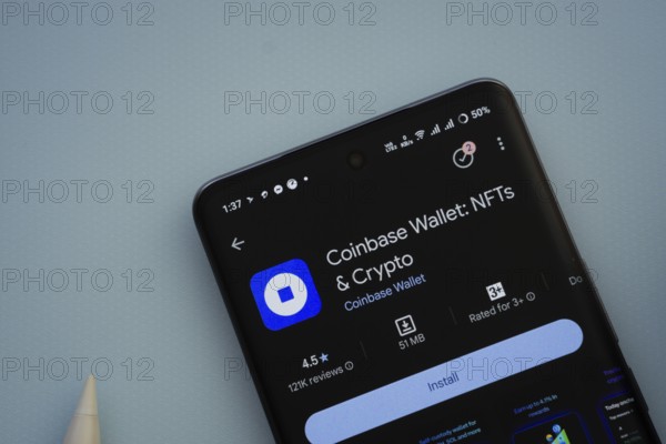 Dhaka, Bangladesh- 29 May 2025: On a blue surface, a smartphone displays the Coinbase app within