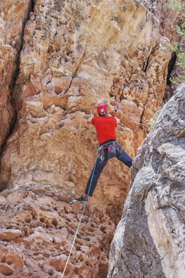 Man rock climbing at The Pit in Sandy's Canyon, Flagstaff, Arizona, USA