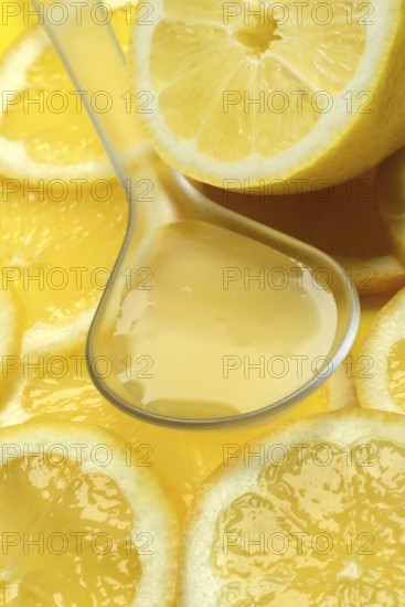 Lemon juice in ladle and lemon slices, Citrus x limon