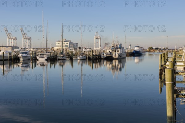 Sailboats and fishing boats docked in the Small Craft Harbor at Gulfport, Mississippi, USA