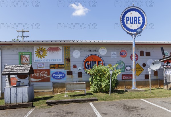 Antique metal advertising signs used for decoration on the side of a building near Counce,