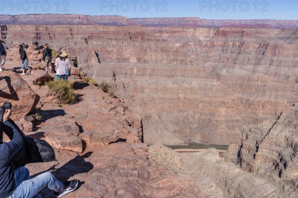 Tourists on the edge of the canyon at Guano Point area of Grand Canyon West near Peach Springs,