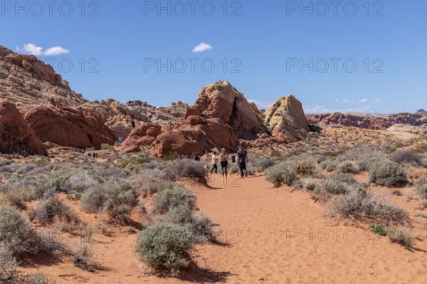 Hikers near the trailhead of the Fire Canyon Overlook Trail at Valley of Fire State Park near