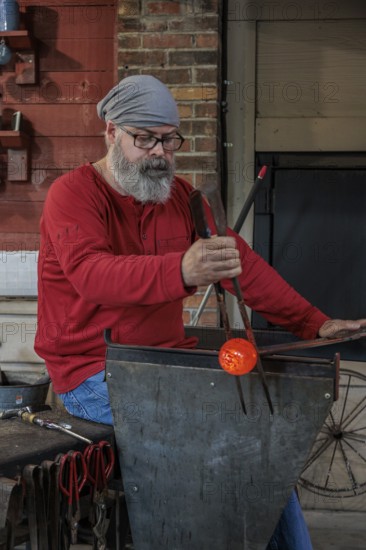 Glass blower demonstrates the art of blowing glass at the Dollywood amusement park in Pigeon Forge,