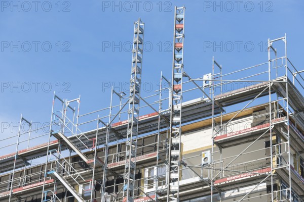 Symbolic image, residential construction, new building, corner building with extensive scaffolding,