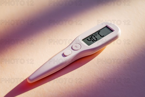 Igital thermometer displaying 40 degrees Fahrenheit, indicating high fever and health alert.