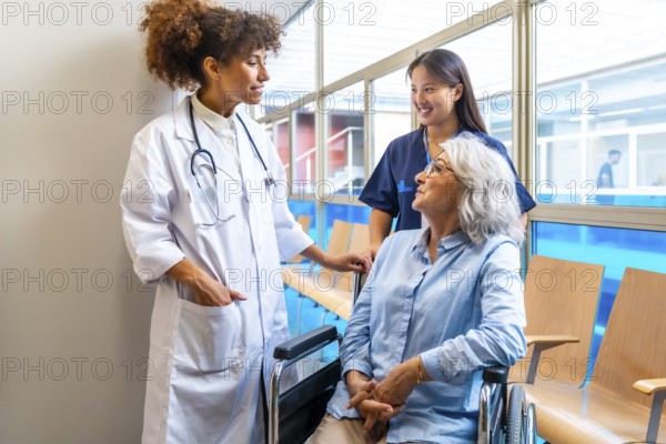 Medical professionals providing care and support to an elderly patient in a wheelchair,
