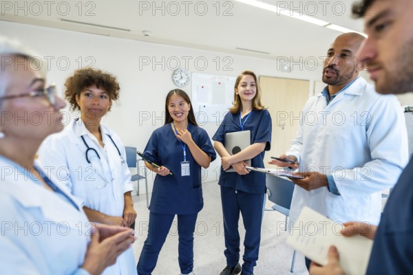 Doctors and nurses engaging in a collaborative discussion during a meeting at the hospital, sharing