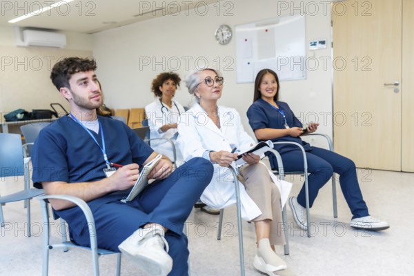 Healthcare professionals listening attentively during a medical conference, taking notes and