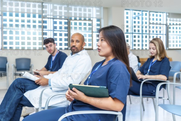 Diverse group of healthcare professionals participating in a medical conference, actively engaging