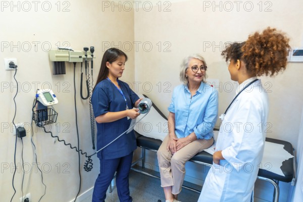 Medical professionals attending a senior woman during a medical checkup, preparing to measure her