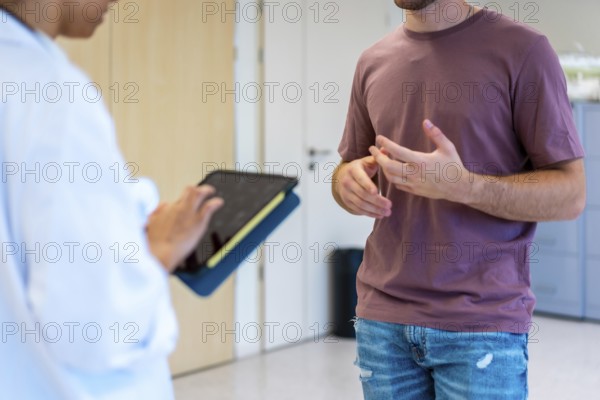 Medical professional using digital tablet while consulting with patient, enhancing healthcare