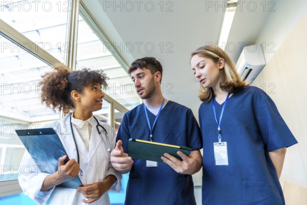 Doctors and nurses examining medical records and x rays, collaborating on patient care in a