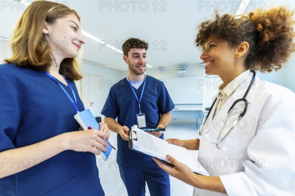 Doctor and nurses reviewing medical records, collaborating on patient care in a bright hospital