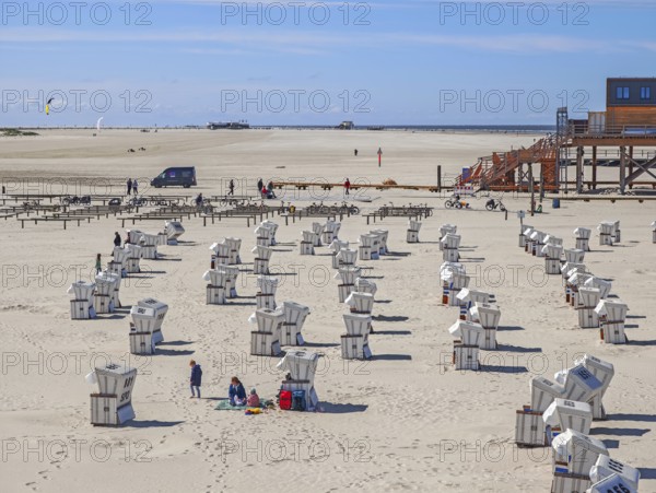 Preparing for the high season on the beach, first guests on the beach, setting up the beach chairs,