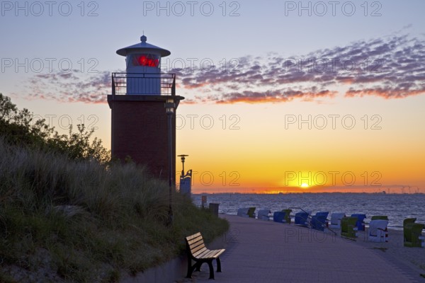 Olhörn lighthouse at colourful sunrise over the sea on the North Frisian island of Föhr,
