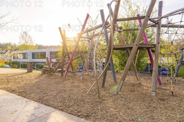 Sunlit playground with wooden climbing structures, Christiane Herzog Realschule, Nagold, district