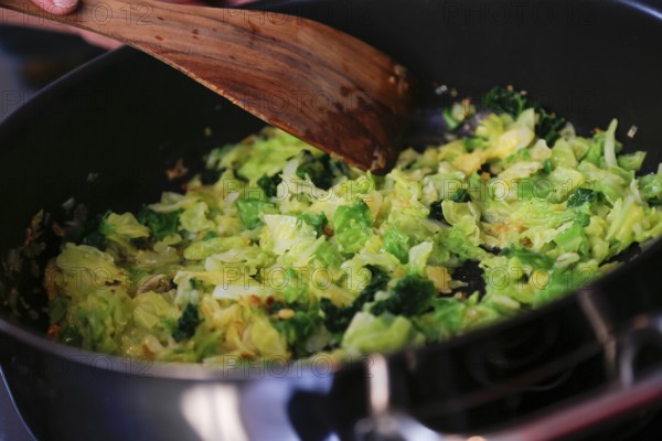 Swabian cuisine, preparation savoy cabbage, wild boar medallions with savoy cabbage cakes, sautéing