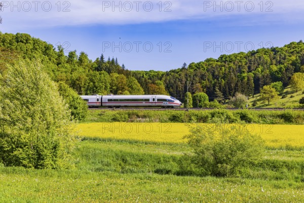 InterCityExpress ICE travelling across the Swabian Alb. Idyllic landscape in spring. Lonsee,
