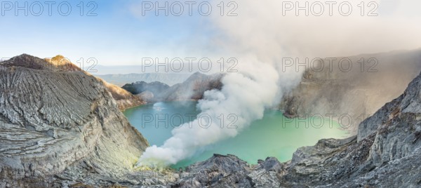 Volcano Kawah Ijen, volcanic craters with crater lake and steaming vents, morning light,