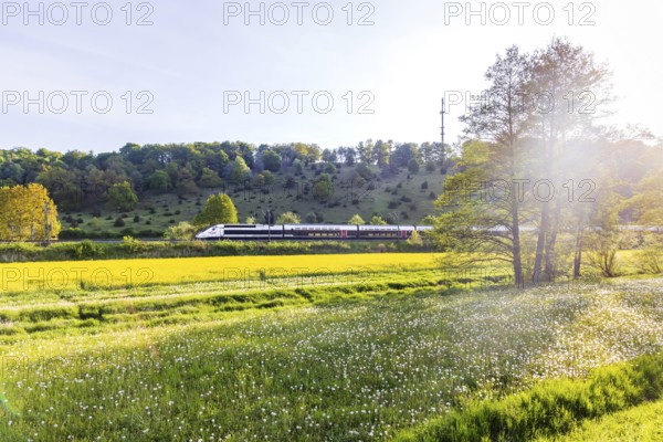 TGV travelling over the Swabian Alb. Idyllic landscape near Lonsee in spring at sunrise. Lonsee,