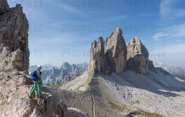 Hiker on the via ferrata to Patternkofel, Northern walls of the Three Peaks, Sesto Dolomites, South