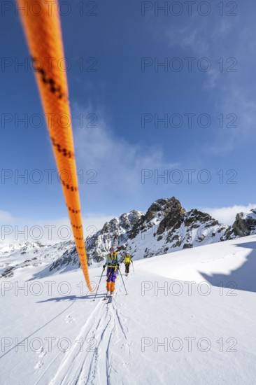 Ski tourer with rope, rope team on the Vadret da Porchabella glacier on the ascent to the summit of