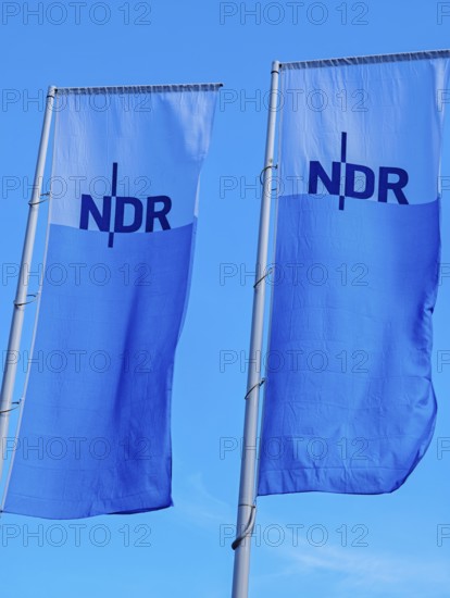 Two flags with lettering NDR, Norddeutscher Rundfunk, flagpoles, colours blue white, light wind,