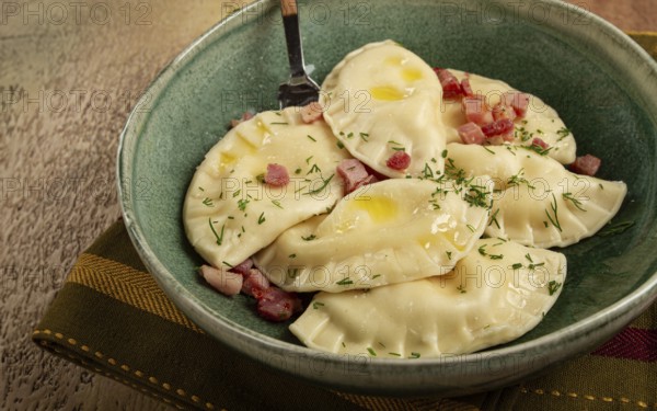 Dumplings, with fried prosciutto, a traditional dish of Polish cuisine, dumplings, top view,