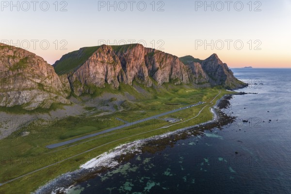 Coast and mountains in the evening light, runway of the abandoned airport, Værøy island, Vaeroy,
