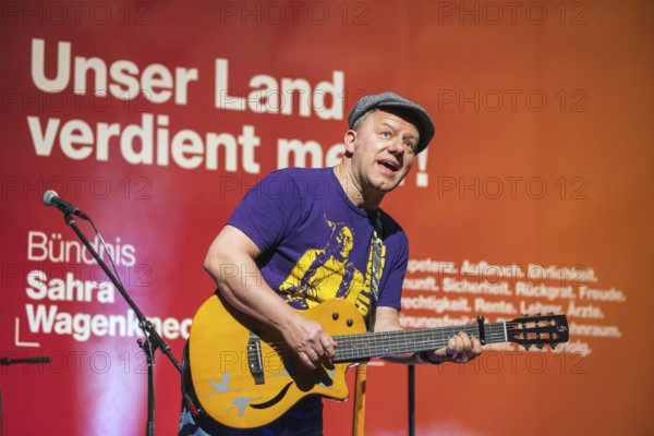 Tino Eisbrenner plays music on stage. Election event of the party Bündnis Sahra Wagenknecht for the