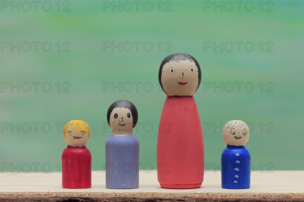 Various large and small colourful wooden cones in front of a painted background, North