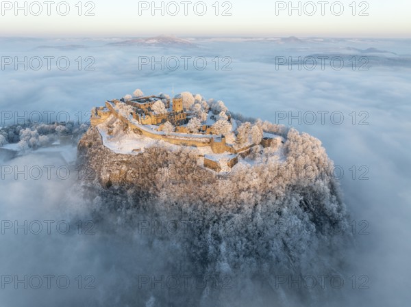 Aerial view of the Hegau volcano Hohentwiel with Germany's largest fortress ruins on a cold, foggy