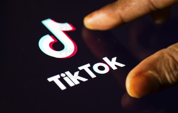 In this photo Illustration a person browsing taps Tiktok Application on a tablet device on 24 May