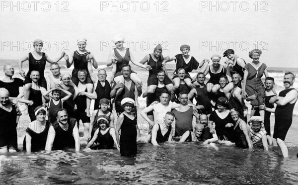 Bathing group on the beach, in the water, piggyback, couples, funny, laughing, summer holidays,