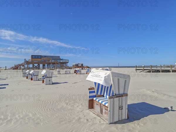 Preparing for the high season on the beach, setting up the beach chairs, North Sea, on the edge of