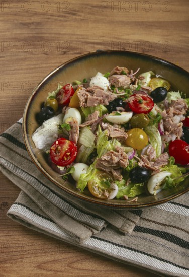 Salad with canned tuna, vegetable salad with quail eggs, lettuce, red onion, cherry tomatoes,