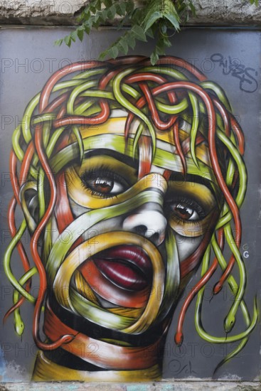 Medusa, female head with hair of colourful snakes, mural in the Anafiotika district, street art,