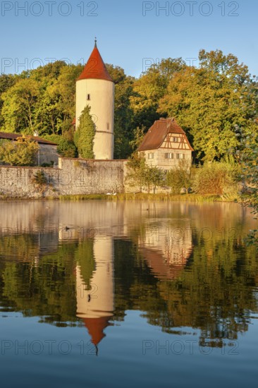 Digester's tower with park keeper's house on the town wall in the morning light, reflection in the