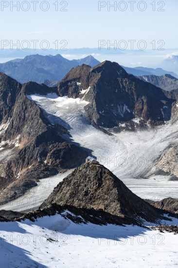 At the Wilder Freiger summit, picturesque high mountain landscape with snow, view of the